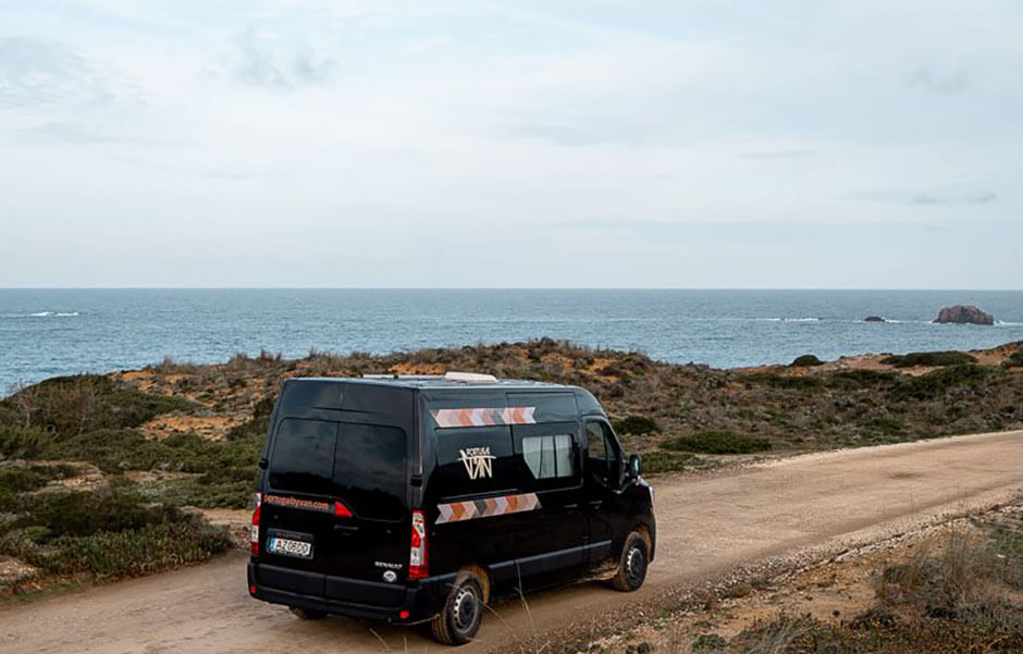 Campervan parked by the coast in Portugal on a road trip adventure